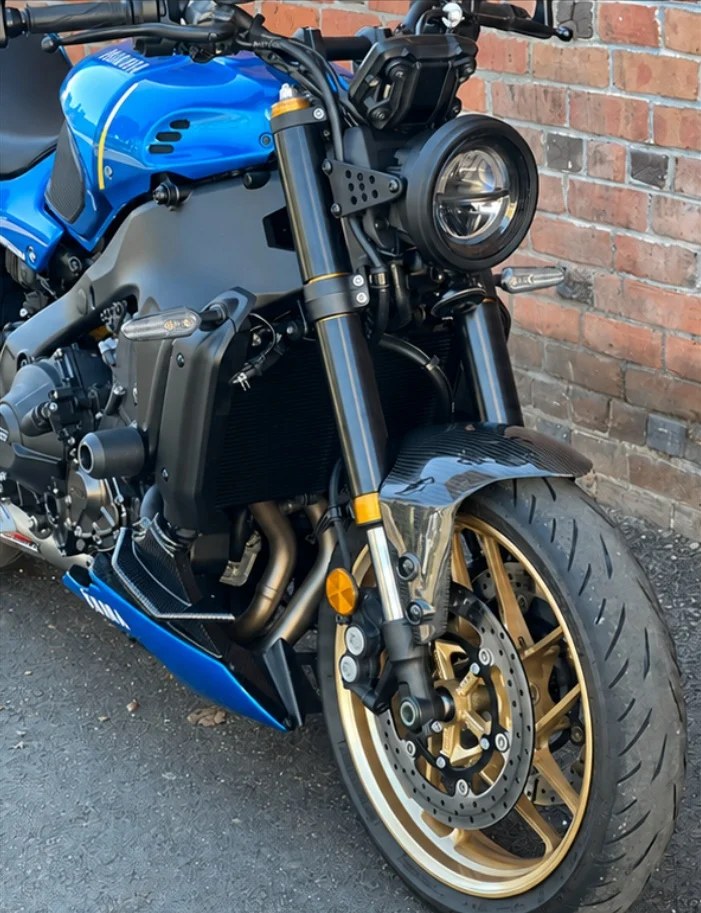 Plain black RokPro fork guards installed on a blue street motorcycle